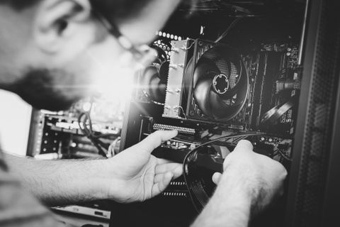 Ein Techniker repariert einen Computerkomponenten in einem Gehäuse. - Datenrettung & Computerservice Andreas Wach