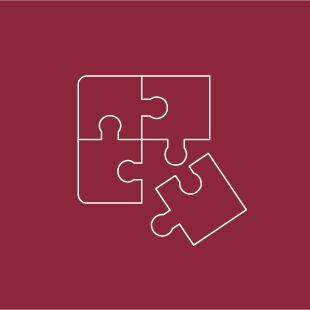 Vier weiße Puzzleteile auf rotem Hintergrund. Symbol für Mergers & Acquisitions, Fusionen und Unternehmenskäufe - TANJA BAUER-ROIKE ÜBERSETZT. Deutsch. Englisch. Rechtliches. Offizielles.