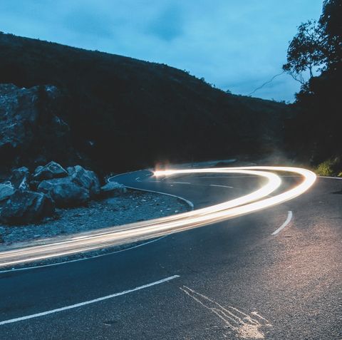 Kurvenreiche Bergstraße bei Nacht mit Lichtspuren von vorbeifahrenden Fahrzeugen - Datenrettung & Computerservice Andreas Wach